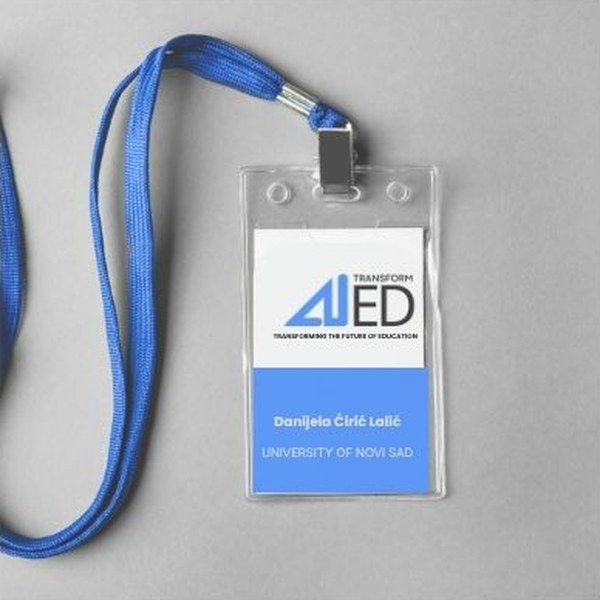 A conference badge on a blue lanyard, for a University of Novi Sad participant