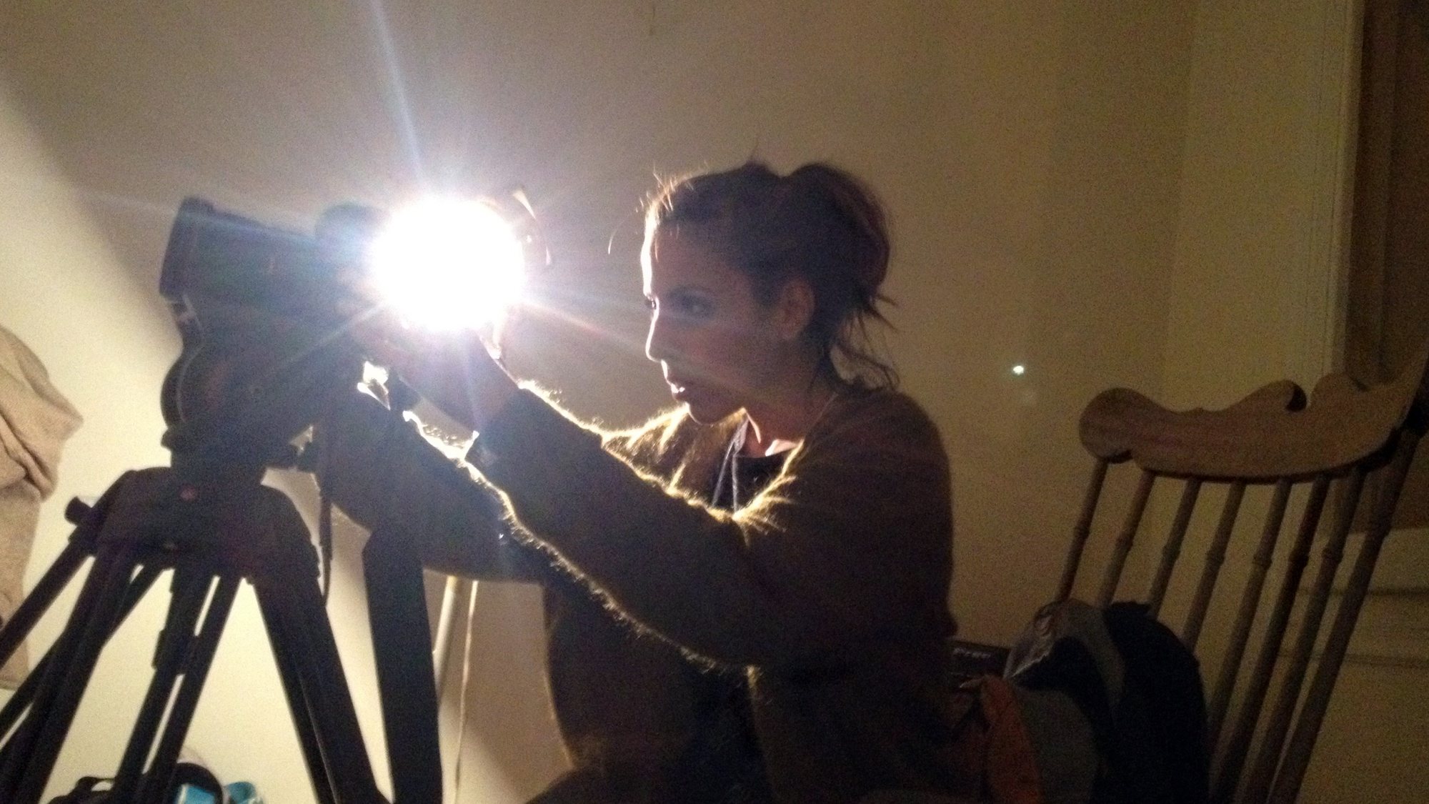 Behind the scenes: a camera and a bright lamp set up for a recording in the flat