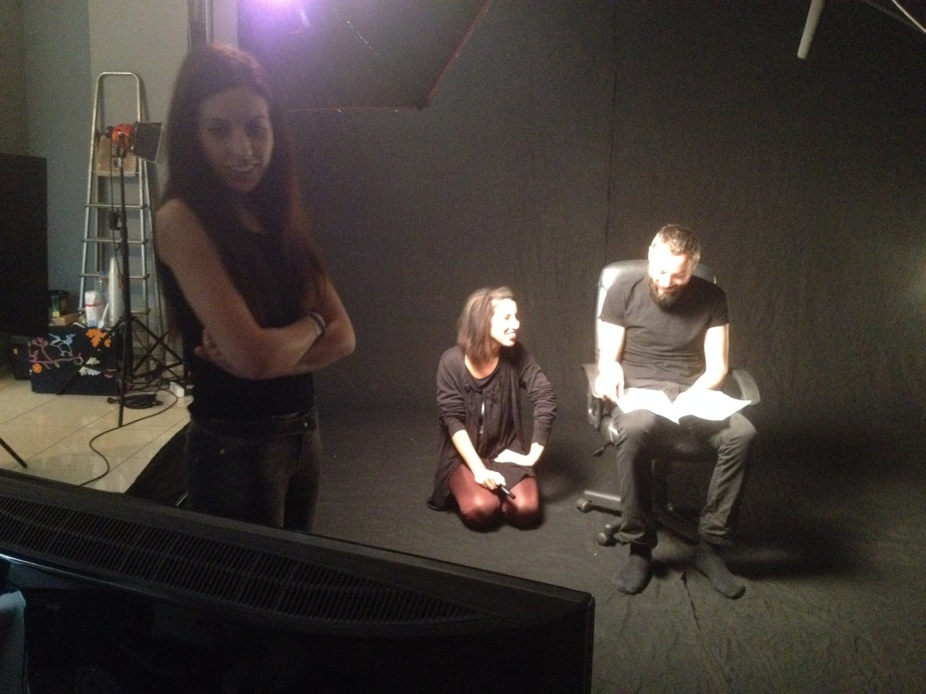 Behind the scenes: a recording session in a studio, the performer seated with the script