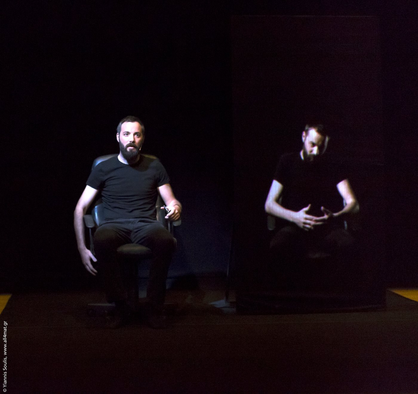 EDIT on stage: the performer seated, and his recorded double seated beside him on screen