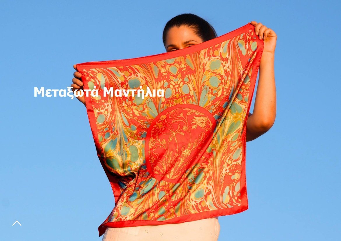 Gift guide page for silk scarves: a woman holding up a red and green marbled scarf against blue sky