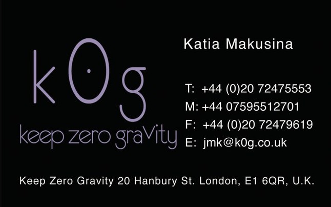 Black business card with the k0g logo in lilac
