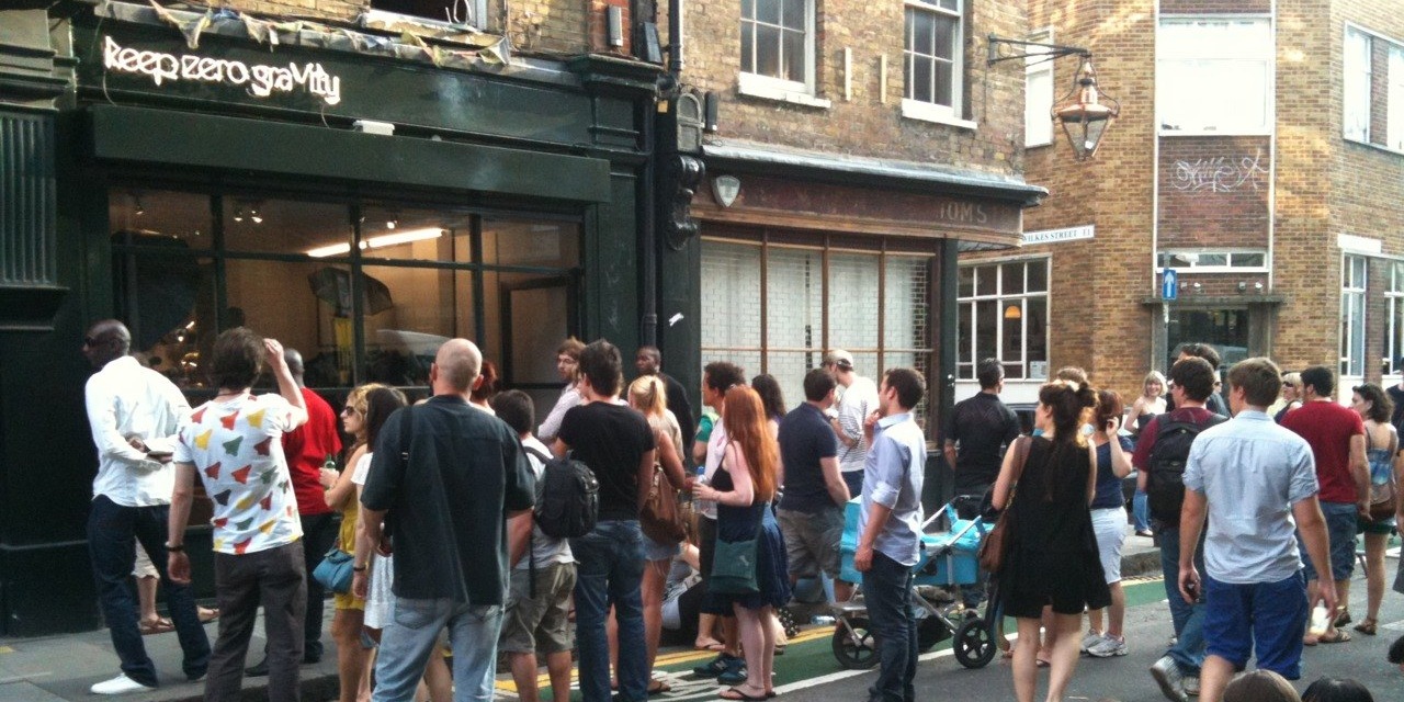 A crowd gathered in front of the shop on Hanbury Street for a window opening