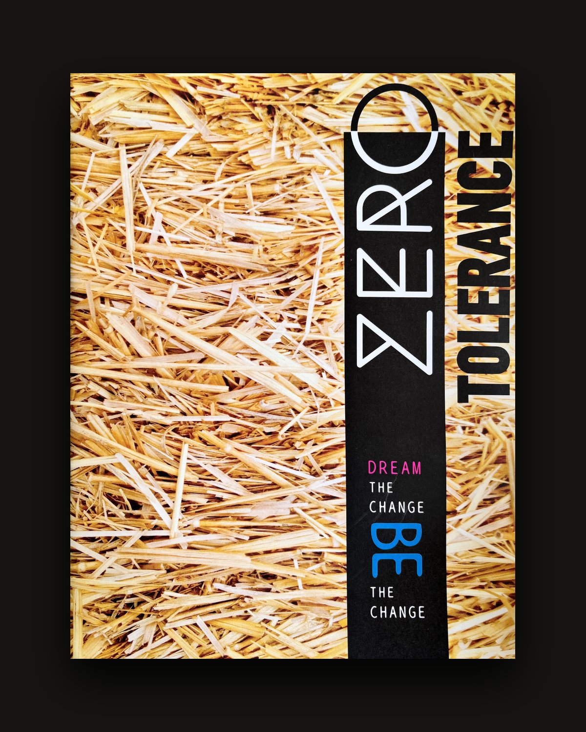 The cover of Issue 0: straw crossed by a black band, with 'Dream the change. Be the change.'